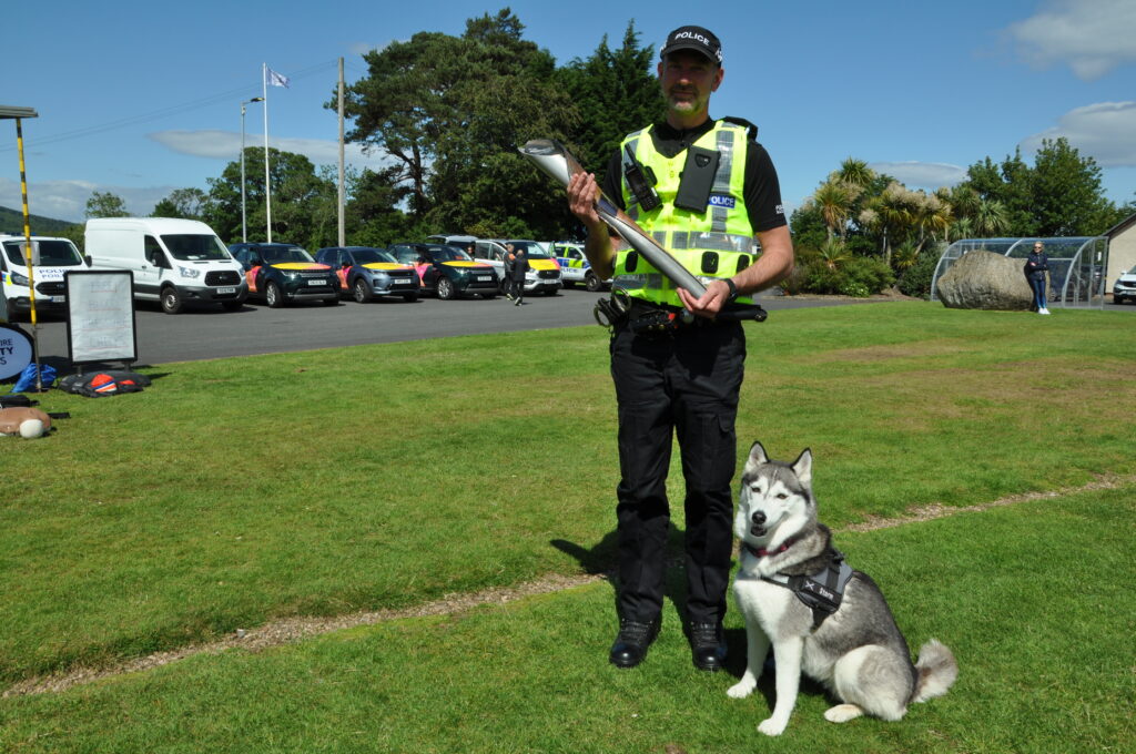 Arran police sergeant Kevin Blackley and Storm with the baton.