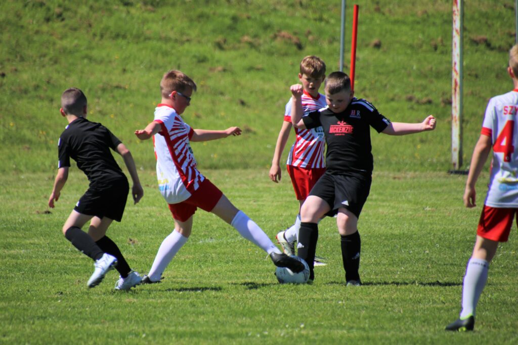 Youngsters from Harmony Row Youth Club and Glasgow Eagles Football Club battle for the ball.