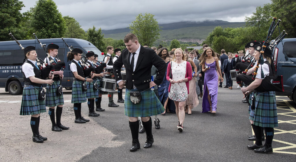 After leading the march from the school, the pipe band parted to form an honour guard for the arriving graduans. Photograph: Iain Ferguson, alba.photos