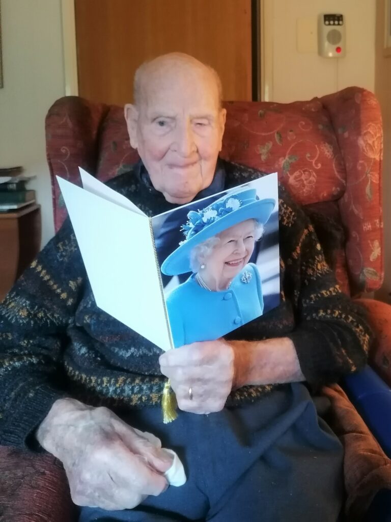 Bob Miller with his 100th birthday card from the Queen.
