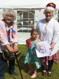 Elizabeth Ball, right, won the competition for the best jubilee hat, with Julie Griffiths, left, runner up. The children's 'portrait of the Queen' prize was won by Arianna Gilchrist.