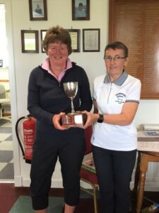 Rona Young being presented with the handicap trophy by lady captain Mary Wilson.