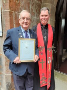 Organist Stuart Irvine, photographed with the Reverend Steve Fulcher, was presented with a certificate to thank him for his service.