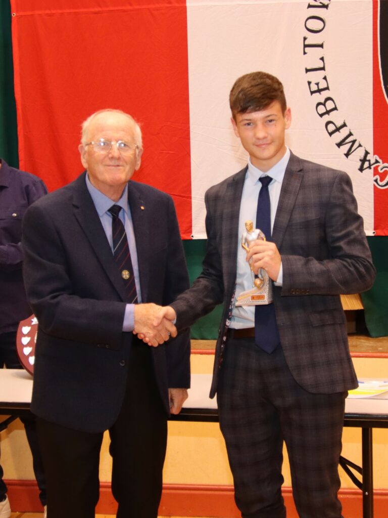 Campbeltown Pupils FC president Alex McKinven presenting Ryan Harding with his players' player of the season award.