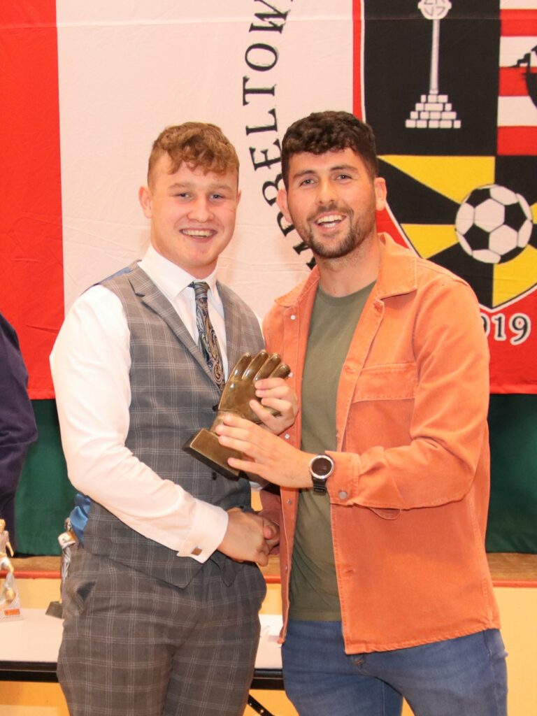Lorne Paterson receiving his prize for save of the season from coach Stuart Crossan.