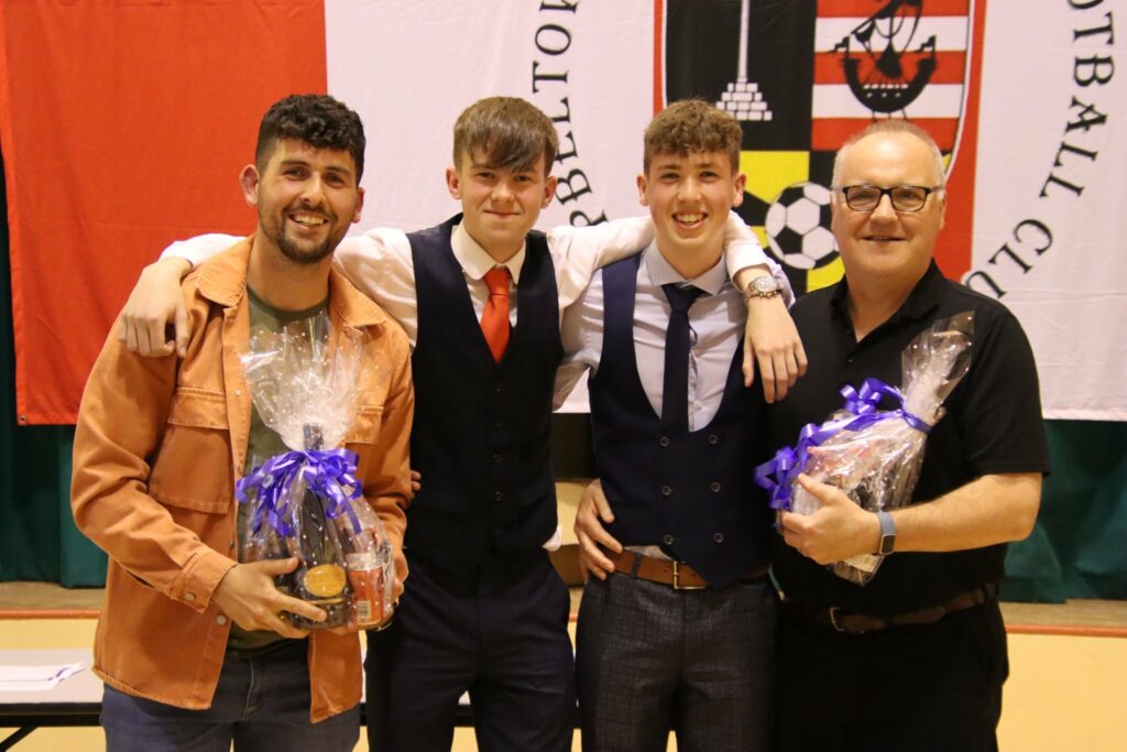 Coaches Stuart Crossan, left, and Peter McCallum, right, receiving gifts from players Scott Graham and Euan Dott.