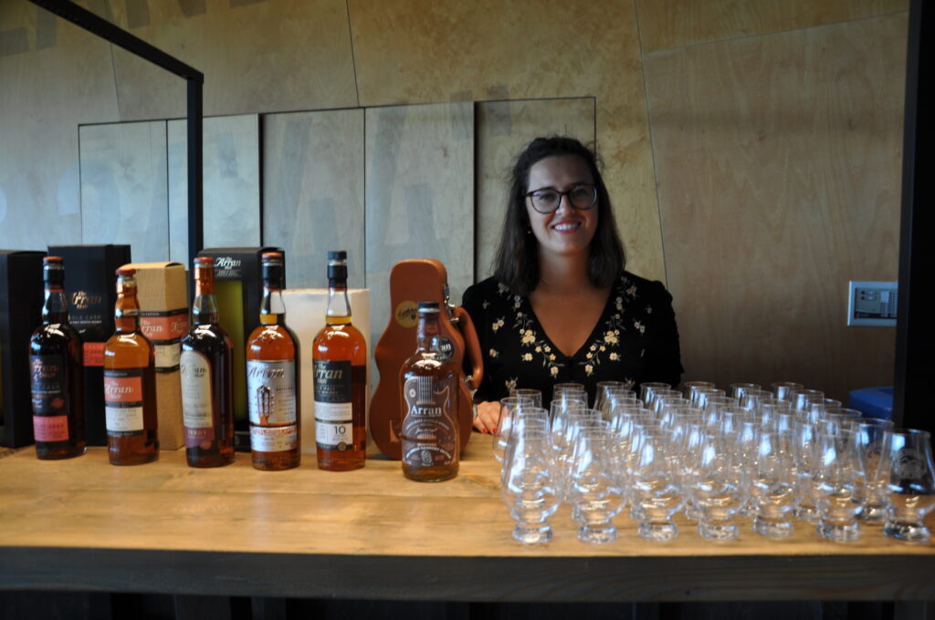 Mariella Romano behind the bar selling a wide range of Arran whisky.