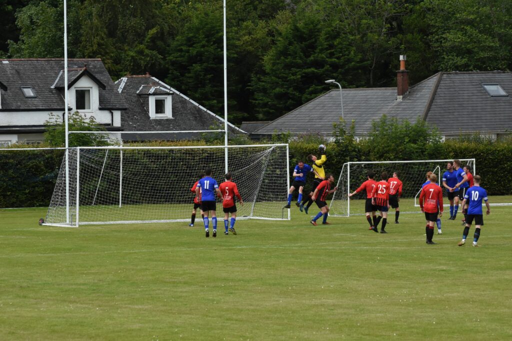 The Arran goalkeeper makes a fine flying save.