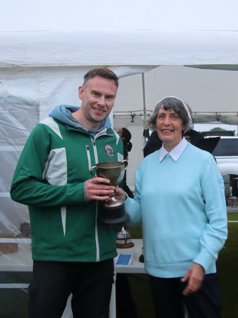 Jennifer McCorkindale presenting Paul Deary, winner of Open Cup and the Neil-John McCorkindale Memorial Cup, with one of his prizes.