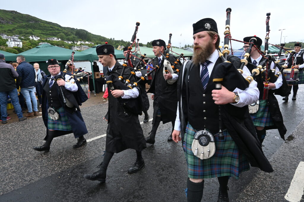 Mid Argyll Pipe Band lead the parade at Tarbert Seafood Festival.