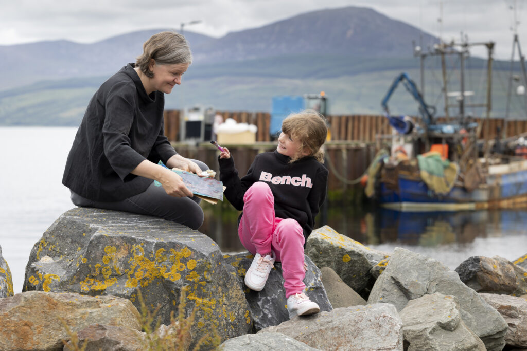Artist Rhona Taylor working with Faith Scott (9) from Carradale Primary School at the pier in the village. Photograph: Martin Shields.