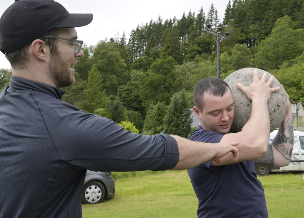 Making his first attempt at a strongman event,  Mikhail Mudrak gets some advice from Tom Baillie of Fort William's Iron Therapy Gym. Photograph: Iain Ferguson, alba.photos.