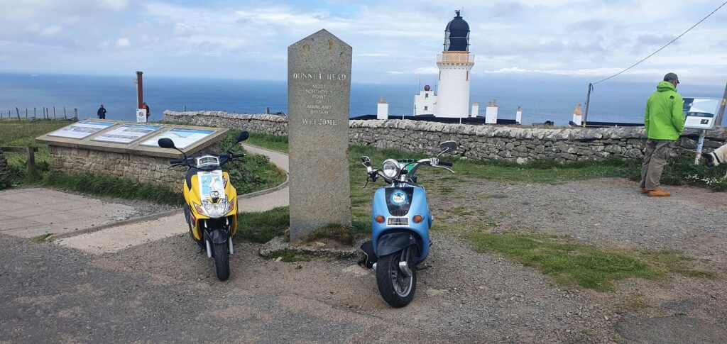 The two moped at the most northerly point of Britain at Dunnet Head.