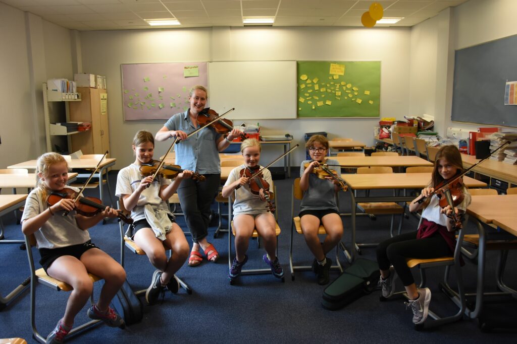 Arran’s own, Gillian Frame with her smiling fiddle pupils.
