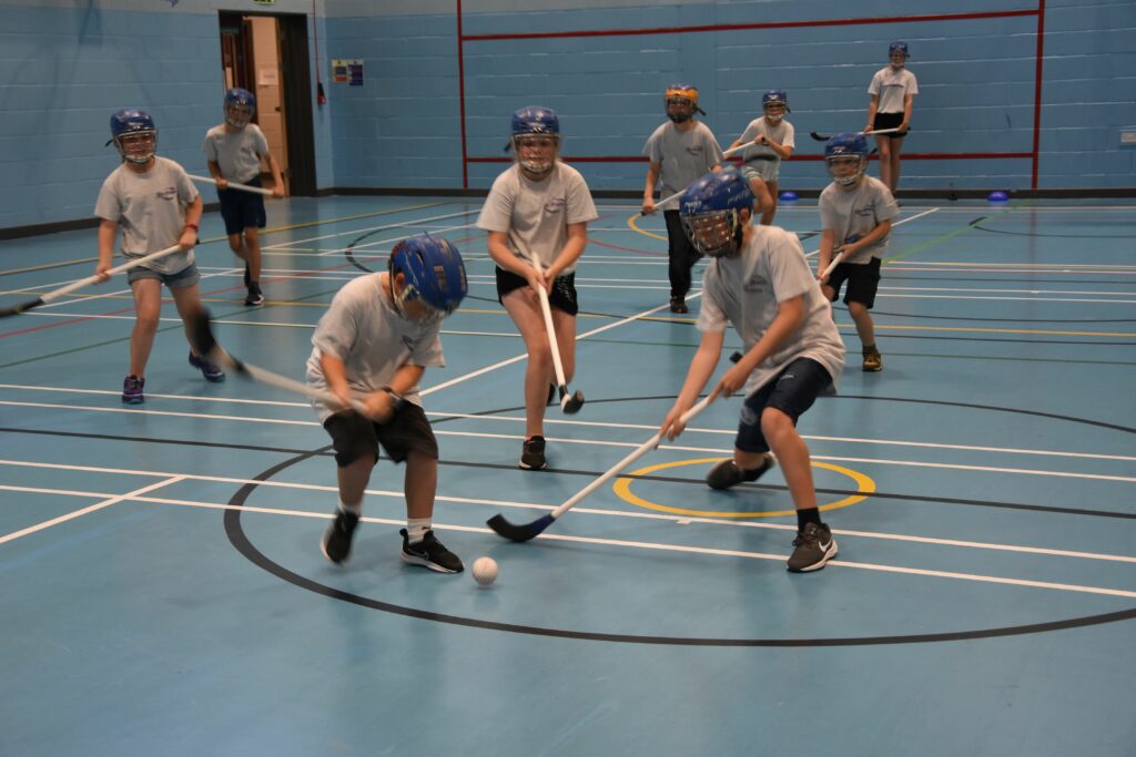 Young players show no restraint in blasting the ball across the indoor court.