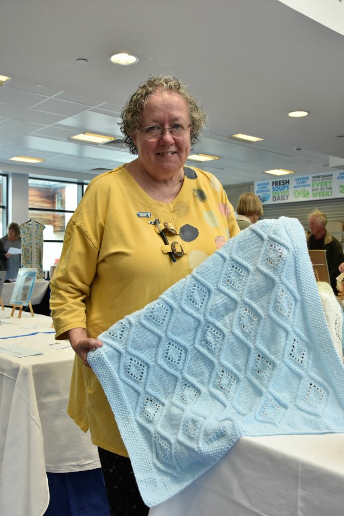 Show convenor Mairi Duff with one of her entries in the knitted item category.