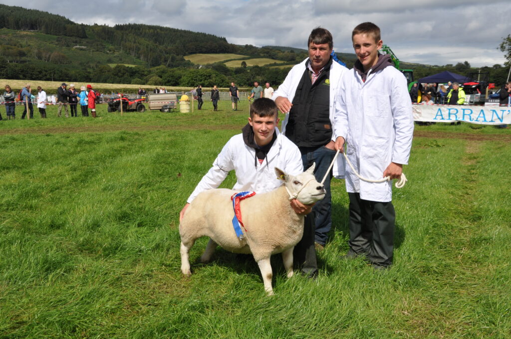 The Currie family, dad Donald and sons Donald and Rory, with their champion beltex ewe.