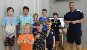  Young footballers who had a mini game on the nearby MUGA pitch were presented with medals at the tea. Photograph: Iain Ferguson, alba.photos NO F32 Lochyside Community Tea 02