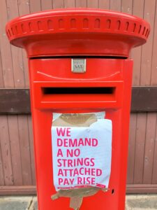 A poster covering the collection times on the post box outside the town's delivery office on Thursday September 8 read: 'We demand a no strings attached pay rise.'