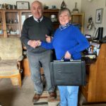 Charlie MacRae handing over the books to new Plockton Village Hall secretary Jill Charnley, after his 60 years in the role. NO F20 Charlie