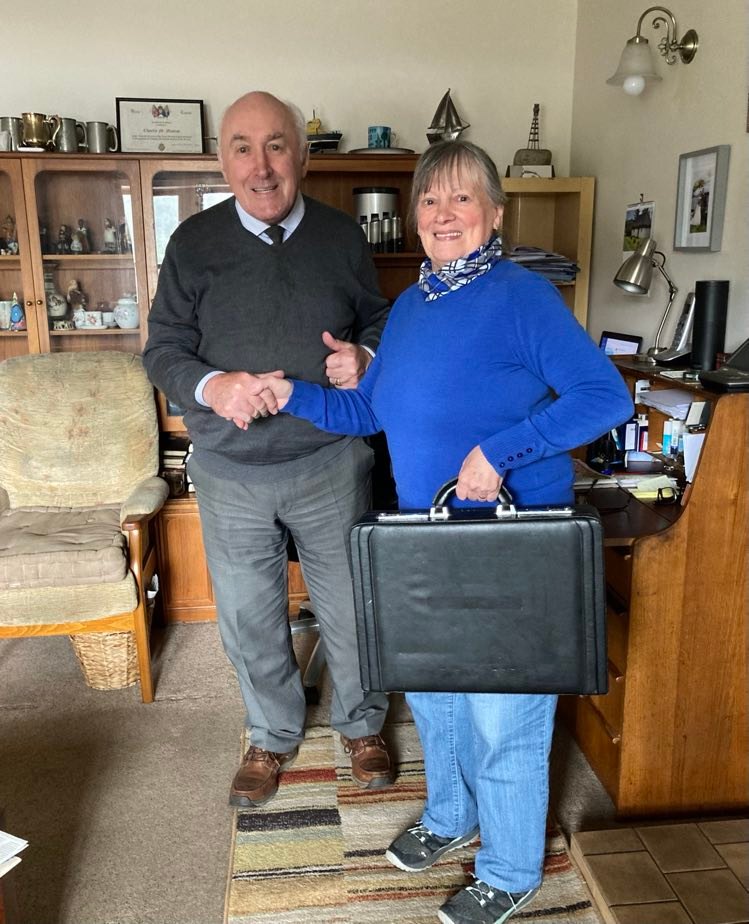 Charlie MacRae handing over the books to new Plockton Village Hall secretary Jill Charnley, after his 60 years in the role. NO F20 Charlie