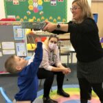 Music therapist Clare Reynolds with some of the Caol school pupils enjoying a session. Photograph: Music Therapy International. NO F27 music therapy 01