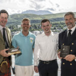 Councillor Angus MacDonald, far left, presents a plaque on behalf of The Highand Council to Amera captain, Odd Jarle Flateboe, far right, with Cruise Director Moritz Stedtfeld, second from left, and Chief Purser Mathias Waschl. Photograph: Iain Ferguson, alba.photos NO F31 Amera visit 02