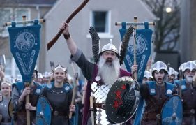 up helly aa included women for the first time this year. Image shows procession during the day led by the Jarl and alongside him is his daughter Jenna, the first female to join.