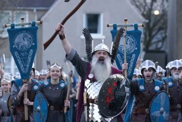 up helly aa included women for the first time this year. Image shows procession during the day led by the Jarl and alongside him is his daughter Jenna, the first female to join.
