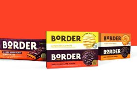 Border biscuit packaging in a variety of flavours and stacked against a solid orange backdrop. This is one of the biggest Scottish brands.