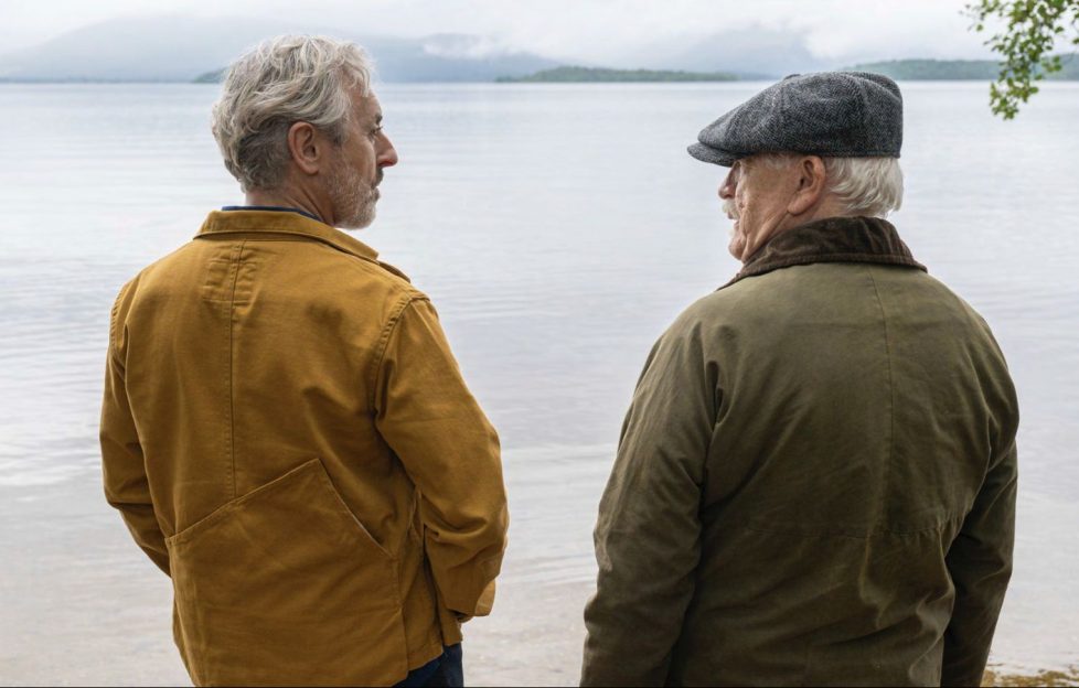 Alan Cummings and Brian Cox standing lochside in a still-frame from the film Glenrothan.