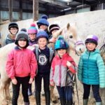 Their smiling faces show how much the youngsters enjoyed their coaching in pony care.