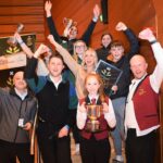 Conductor Stephanie Kennedy and some members of Campbeltown Brass celebrating their triumph at the Scottish Regional Championships – most players had to begin the long return journey to Campbeltown on the bus before the results were announced.