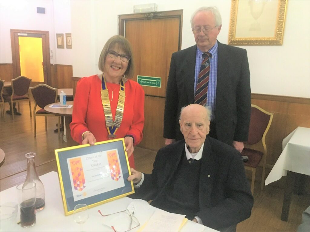 Rotary Club of Campbeltown president Pat Healey presents George McMillan OBE with the Citizen of the Year 2021 Award as president elect Alan Milstead looks on.
