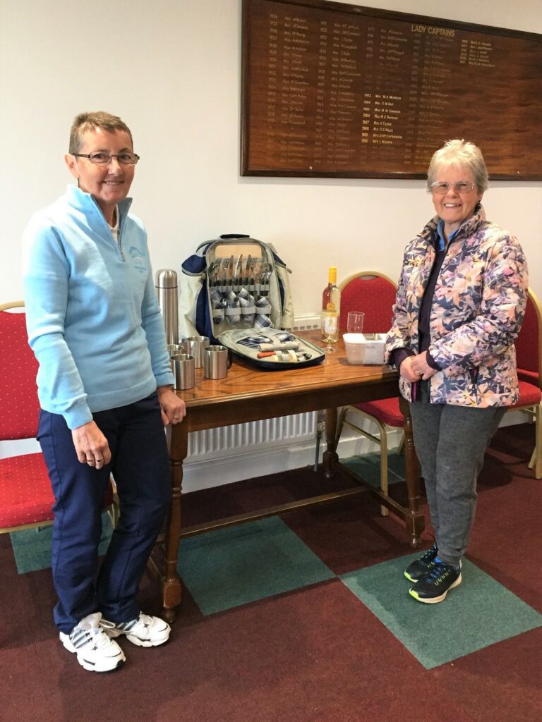 Champion Margaret Richardson, right, receiving the Captain's Prize from Lady Captain Mary Wilson.