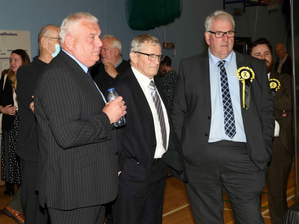 Councillors Donald Kelly, left, and John Armour, right, were re-elected in the South Kintyre ward. Long-serving councillor Rory Colville, centre, lost his seat to newcomer Tommy Macpherson, who was not present at the count. Photograph: Kevin McGlynn.