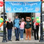 Welcoming browsers to the craft fair, from left: Kate O'May, piper Ewan O’May, Andrina McAulay, beaver and cub section leader Bethany Maclean and Jessie MacPhail.