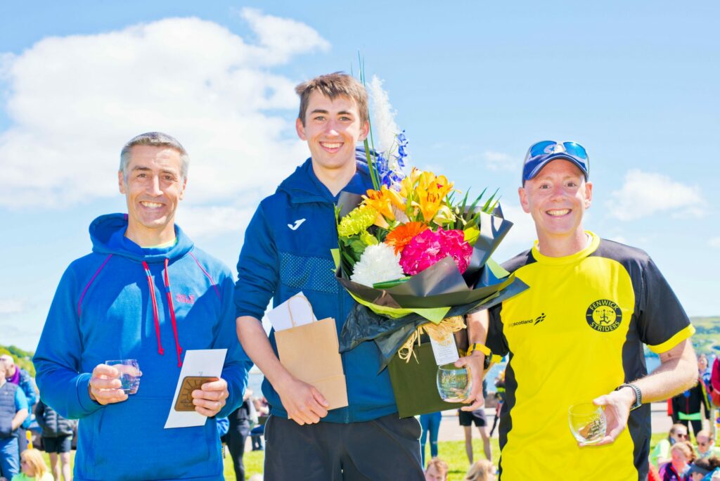 Men's half marathon winner Kieran Cooper, centre, with his dad Richard, who placed second, left, and third placed Neil Nairn, right. Photograph: John McFadyen.