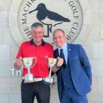 Club captain Darren Kelly, right, presenting Stuart Campbell with the club championship and senior championship trophies.