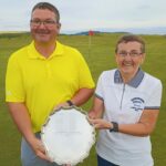 Robert Coffield, winner of the gents' handicap trophy at Dunaverty Golf Club's 2022 Holiday Open, receiving his award from lady captain Mary Wilson.