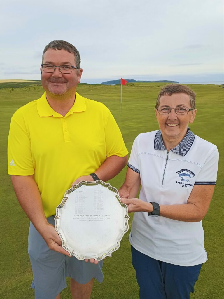 Robert Coffield, winner of the gents' handicap trophy at Dunaverty Golf Club's 2022 Holiday Open, receiving his award from lady captain Mary Wilson.