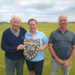 Mixed pairs winners Sandy Watson and Margaret Moore receiving their trophy from club captain Donald Brown (Southend).