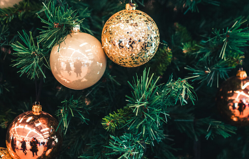 Close up of golden bauble on Christmas tree