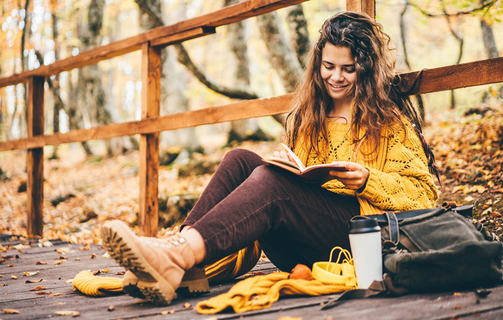 Woman in forest writing a journal outside Pic: Shutterstock