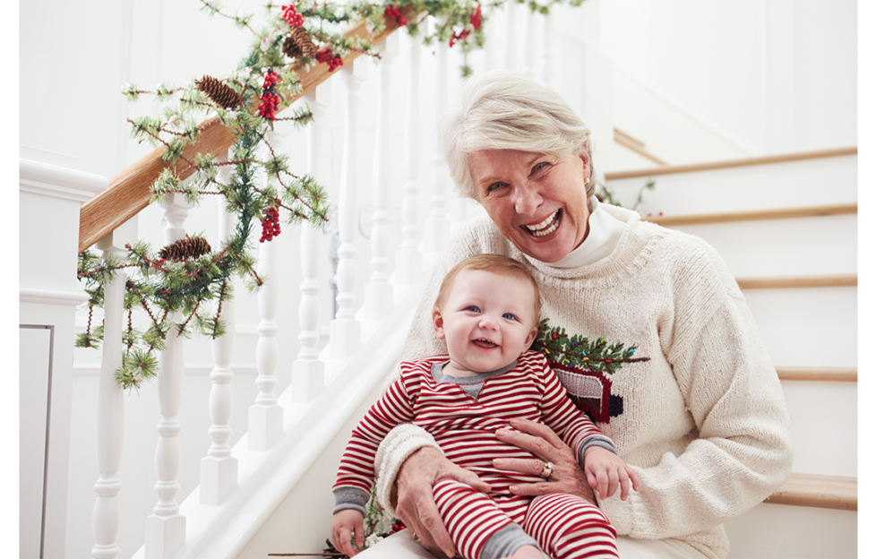 Grandmother on stairs with baby at Christmas