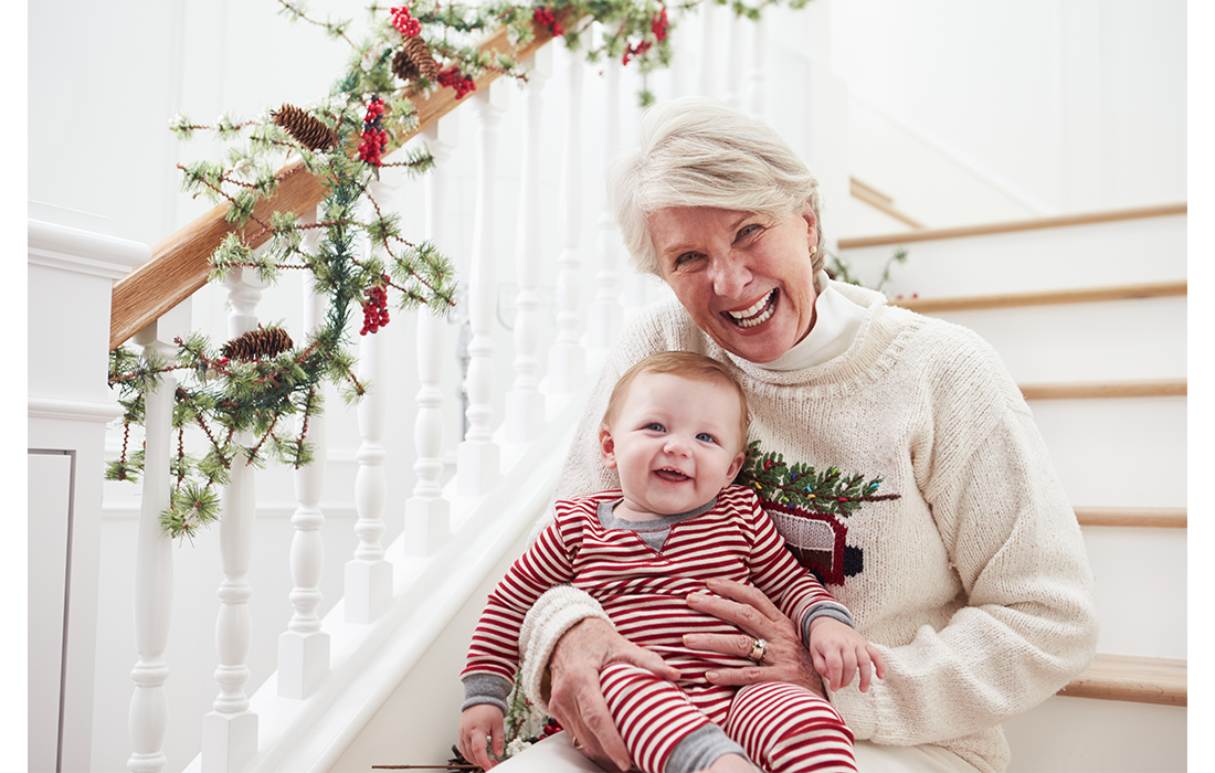 Grandmother on stairs with baby at Christmas