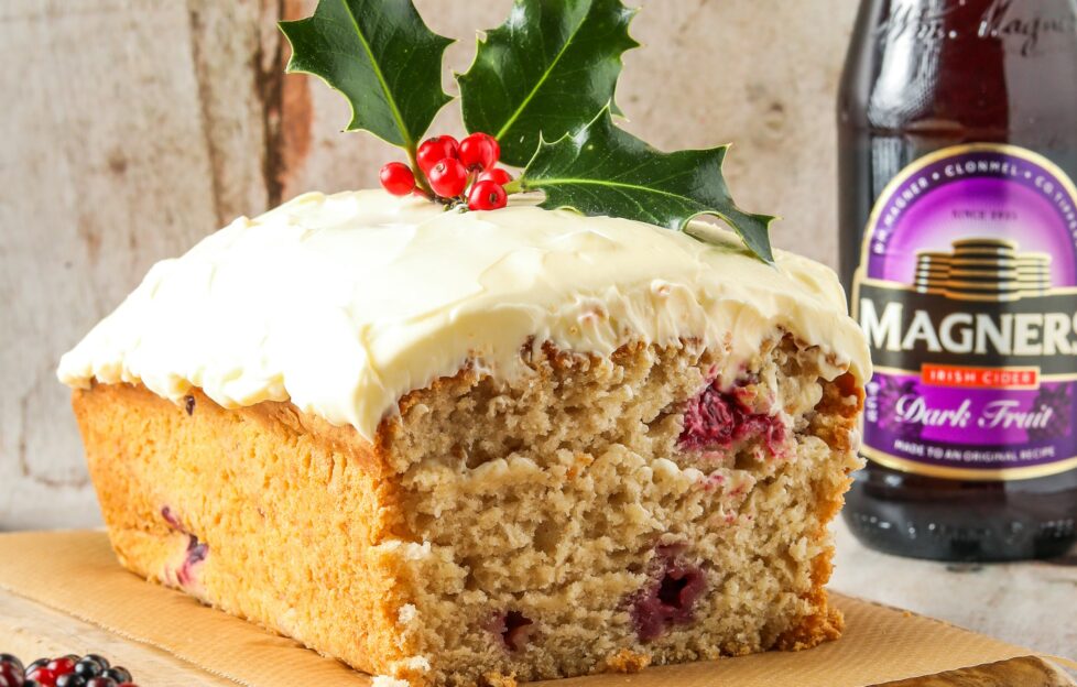 Light fruit cider loaf with icing and sprig of holly, Magners cider bottle at side