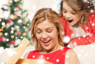 Lady opening a gift Pic: Shutterstock