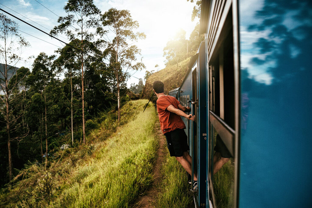 Taking in the scenery on a train ride in Sri Lanka as this young traveller heads to his next destination, photographed by Jonathan Sterz.