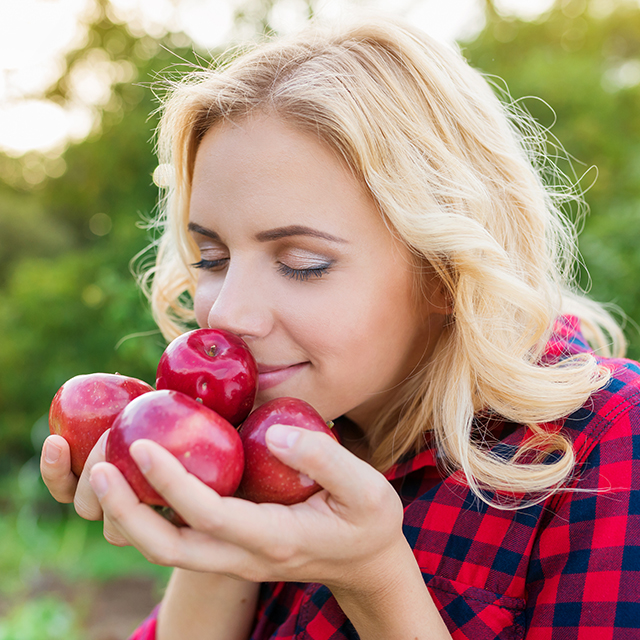 Woman smelling apples Pic: Shutterstock